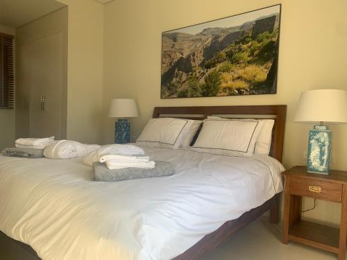 a bedroom with a bed with white sheets and pillows at Townhouse Paolo in Salalah