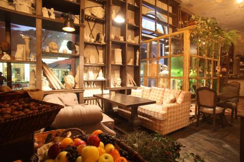 a living room with a couch and a table with fruits at Monte Carlo in Batumi