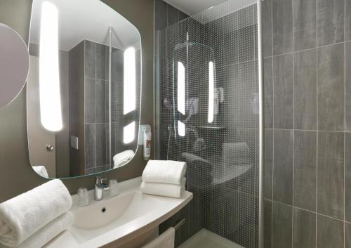 a bathroom with a sink and a mirror at Ibis Irun in Irún