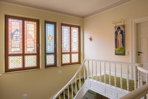 a staircase in a home with stained glass windows at Kloster Bonlanden in Berkheim