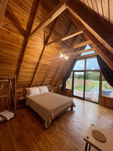 a bedroom with a bed in a room with wooden ceilings at Heaven Bungalow Fethiye in Fethiye