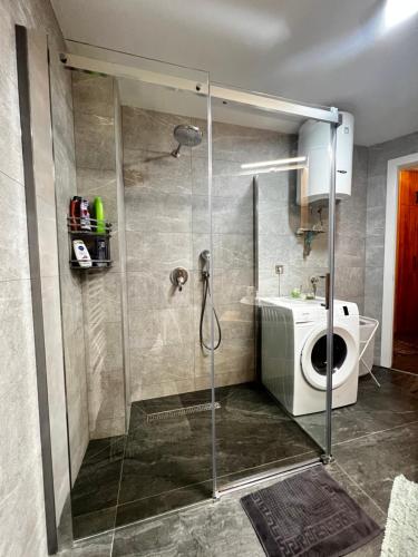 uma casa de banho com um chuveiro, um WC e um lavatório. em Emma Park Lake em Tuzla