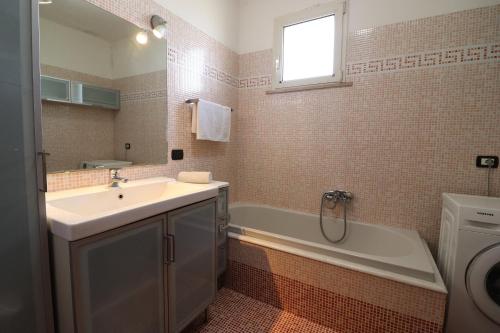 a bathroom with a sink and a bath tub at Elegant Holiday Home for 67 Guests in the Heart of Otranto in Otranto