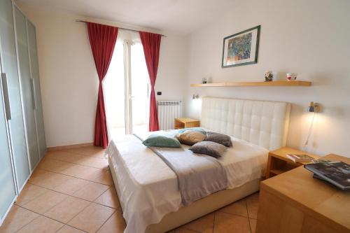 a bedroom with a large bed with red curtains at Elegant Holiday Home for 67 Guests in the Heart of Otranto in Otranto