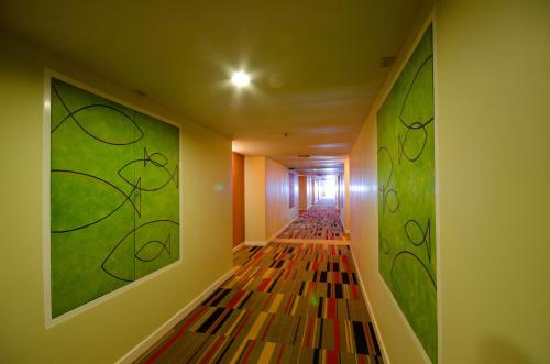 a hallway with a long aisle with stained glass at Tongtara Riverview Hotel in Bangkok