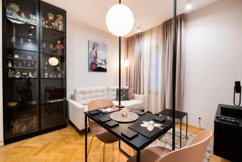 a living room with a black table and chairs at MOSTOWA Abdank Old Town Apartment in Warsaw