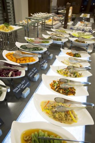 a row of plates of food on a table at Seoul Garden Hotel in Seoul