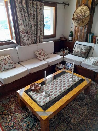 a living room with a couch and a coffee table at Attico Vittoria in Rivisondoli