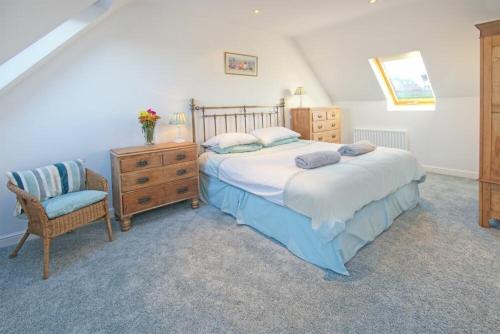 a bedroom with a bed and a chair and a dresser at The Villas No3 in Embleton