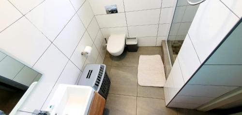 a bathroom with a toilet and a sink at Ramsgate Rendezvous 13 - Sleeps 6 - Great Sea Views! in Margate