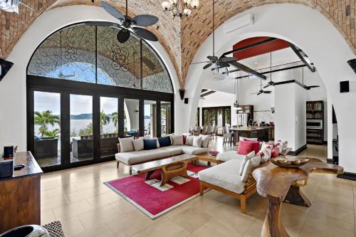 sala de estar con sofá, mesa y sillas en Ocean-View Flamingo Palace with Stone Courtyard and Giant Infinity Pool, en Playa Flamingo