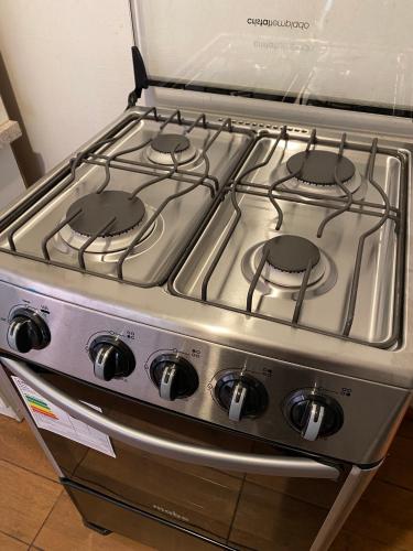 a stove top oven with four burners on it at Casa y departamentos amoblados Talca in Talca