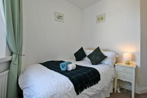 a bedroom with a bed with two towels on it at Sea Air in Amble