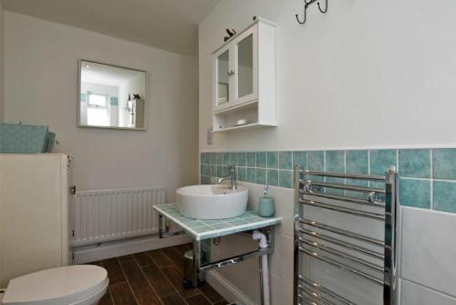 a bathroom with a sink and a toilet at Sea Air in Amble
