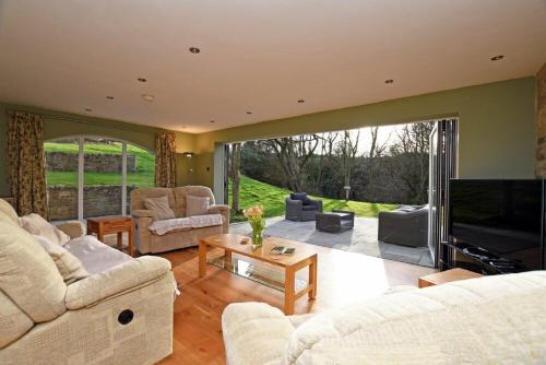a living room with two couches and a television at Quarry Haven in Bamburgh