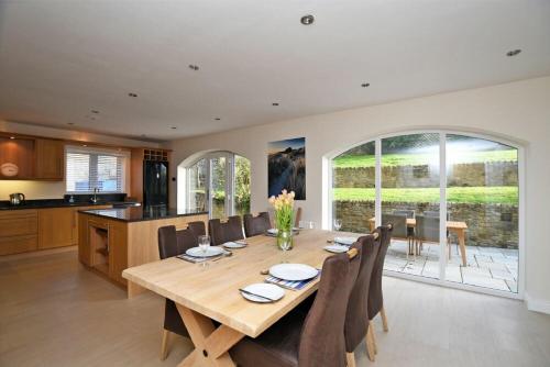 a kitchen and dining room with a wooden table and chairs at Quarry Haven in Bamburgh
