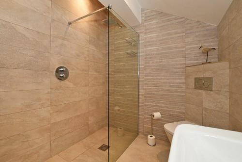 a bathroom with a shower with a glass door at The Pepper Pot in Warkworth