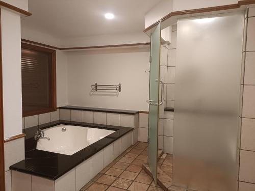 a bathroom with a bath tub and a shower at Pd full seaview deluxe in Port Dickson
