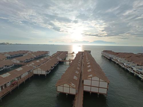 an aerial view of a group of huts in the water at Pd full seaview deluxe in Port Dickson