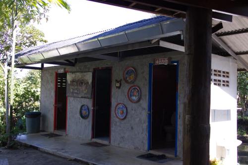 a building with blue doors and plates on it at Art House at Chiangdao - Waterlily House in Chiang Dao