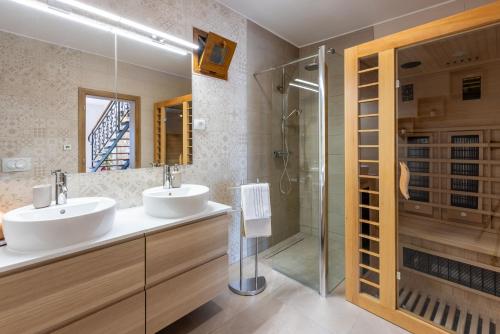 a bathroom with two sinks and a shower at Villa Banely in Grižane