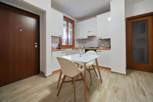 a kitchen with a table and chairs in a room at Flat Number 8 in Milan