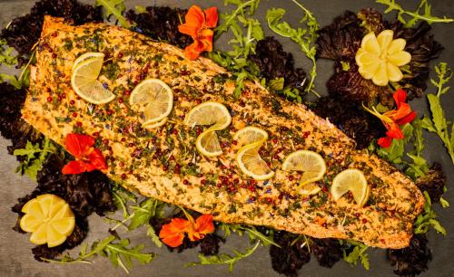 a piece of fish with lemon slices on top at Hotel Bamboo in Coldrano