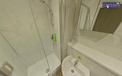 a bathroom with a shower and a toilet and a sink at Signature House - Contemporary Studios in Coventry City Centre, free parking, by COVSTAYS in Coventry