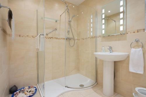 a bathroom with a shower and a sink at Summerfold in Warkworth