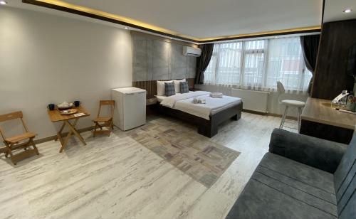 a room with a bed and a table and a couch at Blue Mansion Hotel & Flats in Istanbul