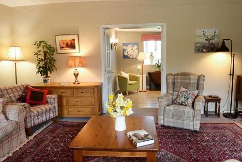 a living room with two couches and a coffee table at Laverstock Cottage in Bridport