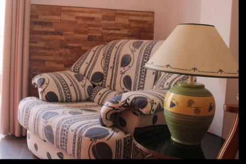 a lamp sitting on a table next to a couch at Casa Andreia, close to everything in Lagos