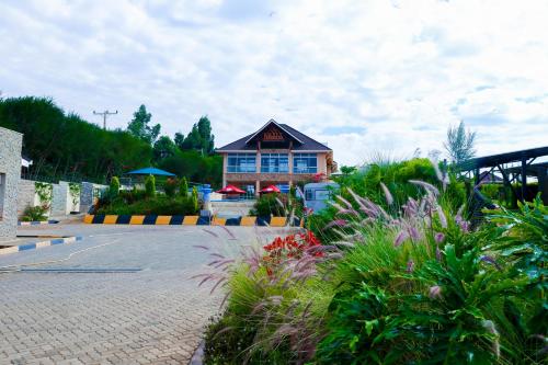 a building on a street with plants in front of it at Aberdare Prestige & Royal Cottages in Nanyuki