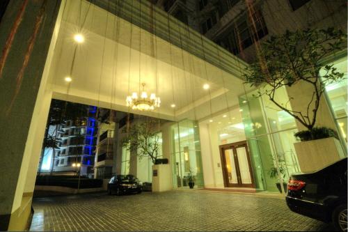 a building with a car parked in front of it at Wedgewood Residences in Kuala Lumpur
