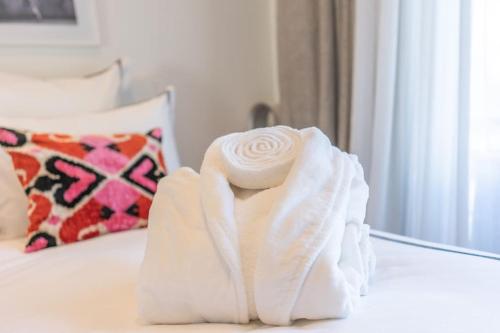 a pile of towels sitting on top of a bed at Luxury Apartment - 150m to Palais des Festivals ( Cannes ) in Cannes