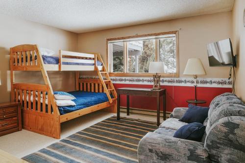 a living room with bunk beds and a couch at The Hip Rose in Big Sky