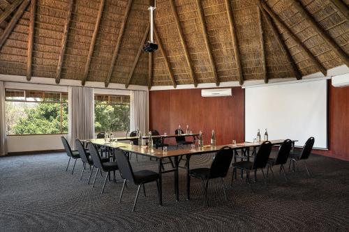 a large conference room with a long table and chairs at Premier Hotel Roodevalley in Pretoria