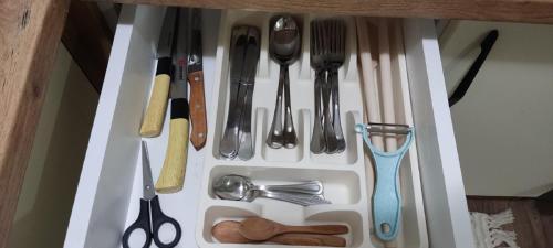 a drawer filled with utensils in a cabinet at Sova in Kopaonik