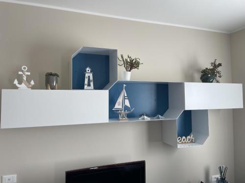 a white shelf with a toy sailboat on it at Appartamento Luigi in Ventimiglia