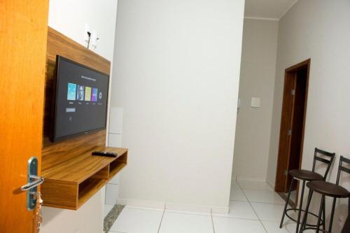 uma sala de estar com uma televisão de ecrã plano na parede em 204-FLAT-Espaço,conforto.È disso que você precisa! em Anápolis