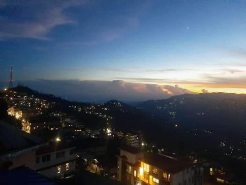 a view of a city at night at Swastika Homestay and Travels Kurseong Bazar Near HDFC Bank NH55 Road Kurseong in Kurseong