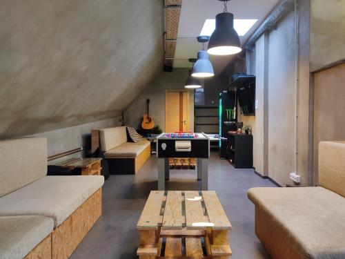 a living room with a ping pong table and a couch at Main Square Hostel in Zagreb
