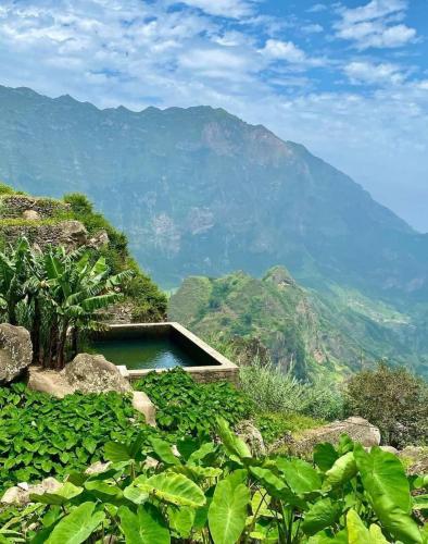 a swimming pool on a hill with mountains in the background at Pam de Terra in Palha Carga