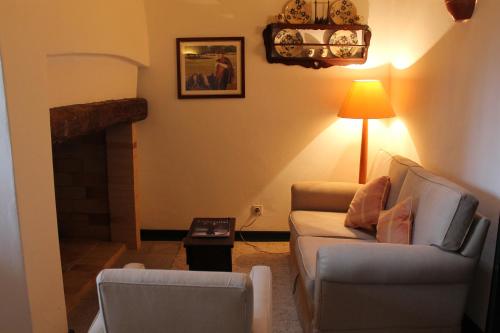 a living room with a couch and a fireplace at Casa de Viana do Alentejo in Viana do Alentejo