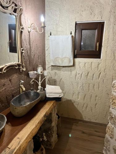 a bathroom with a stone sink and a mirror at giagias family farm in Kranidi