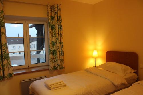 a bedroom with a bed and a window at La Bullote - Gîtes - Paris Roissy CDG in Villeneuve-sous-Dammartin