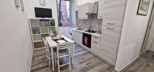 a kitchen with a small table and a stove at R.&T. Suite House Roma in Rome