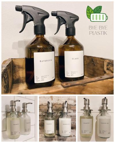 a group of four bottles of essential oils in a wooden box at ALTE SCHULE WITTENBERG, 3 Ferienwohnungen für bis zu 12 Personen, an der Elbe, mit Garten in Lutherstadt Wittenberg