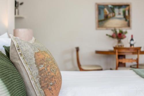 a bedroom with a bed with a rusted pillow at Far Horizons Camps Bay in Cape Town