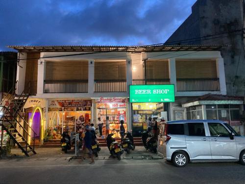 a small car parked in front of a store at Dip N Doze in Ahangama